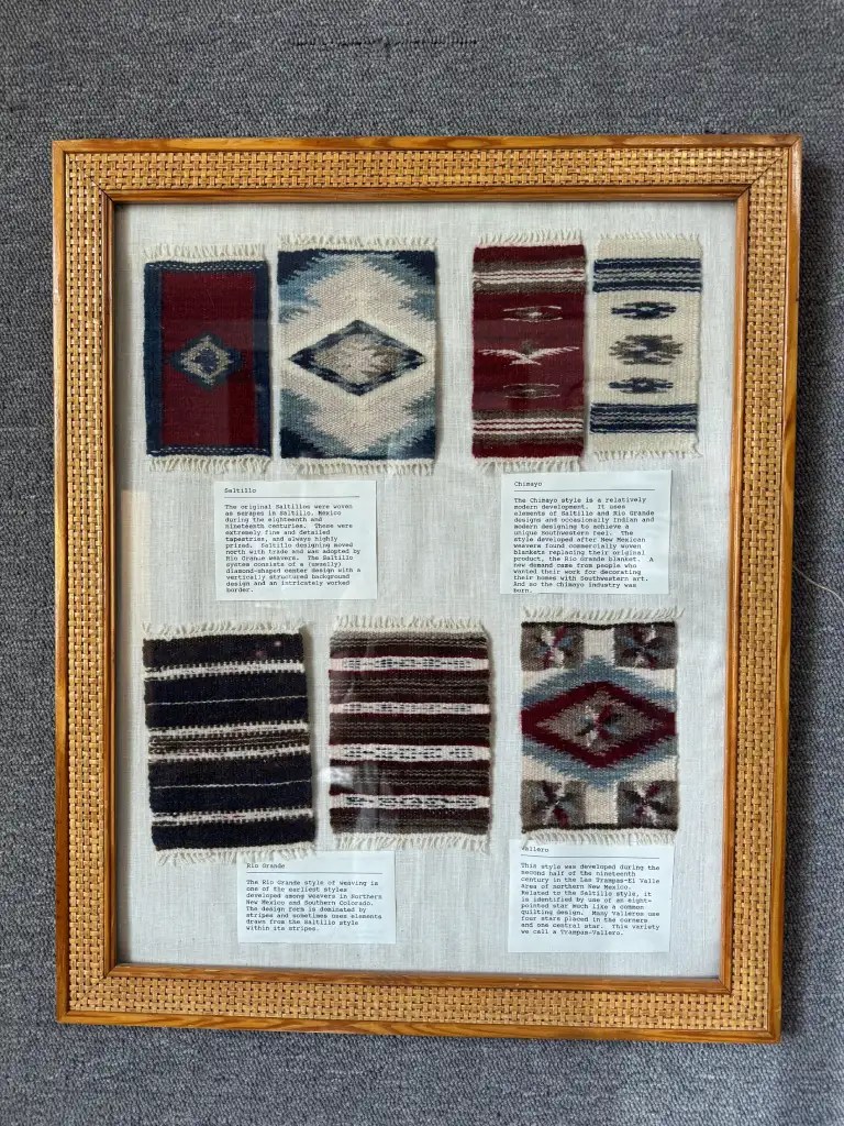 A framed display featuring various textile patterns, including traditional designs such as Saltillo, Chimayo, Rio Grande, and Gallup styles, with descriptive labels providing information about each weaving technique.
